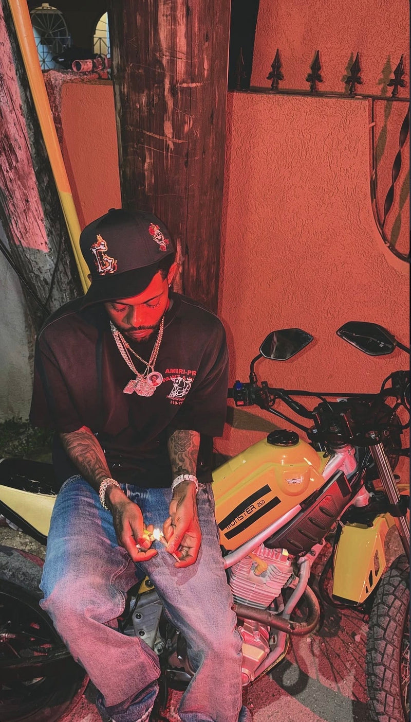 Skippa Spotted Wearing the G Flames Hat in “Duppyman Style” Music Video